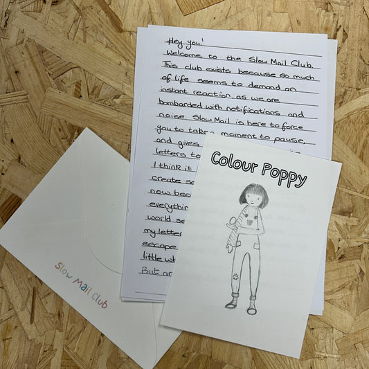 Two pieces of paper with text and a drawing on a wooden surface