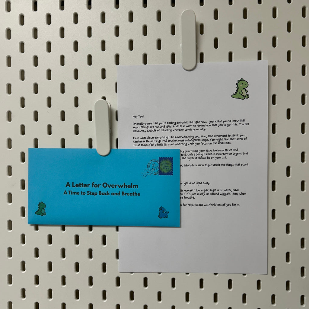 Letter for Overwhelm and blue envelope on a pegboard