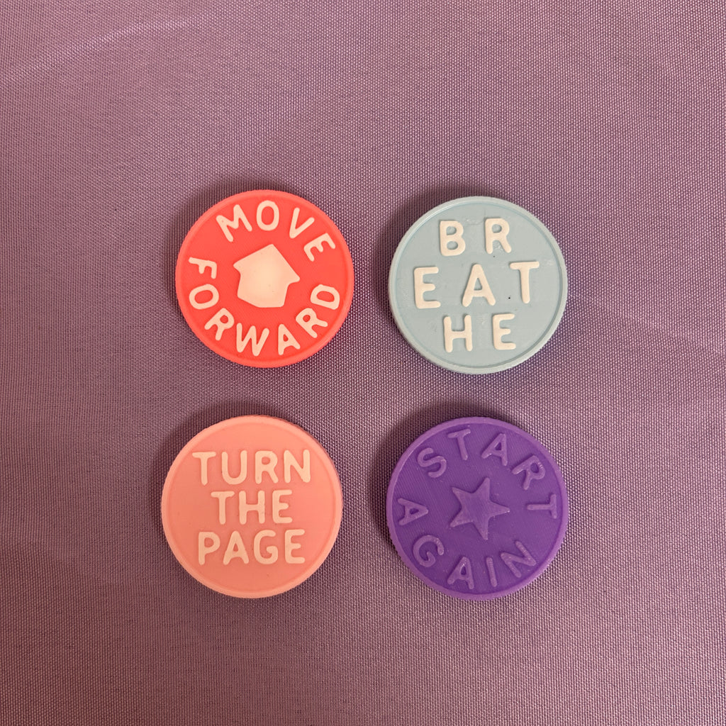 Four circular motivational stickers arranged in a 2x2 grid on a textured mauve background. The top-left sticker is coral orange with the text 'MOVE FORWARD' and a house icon.