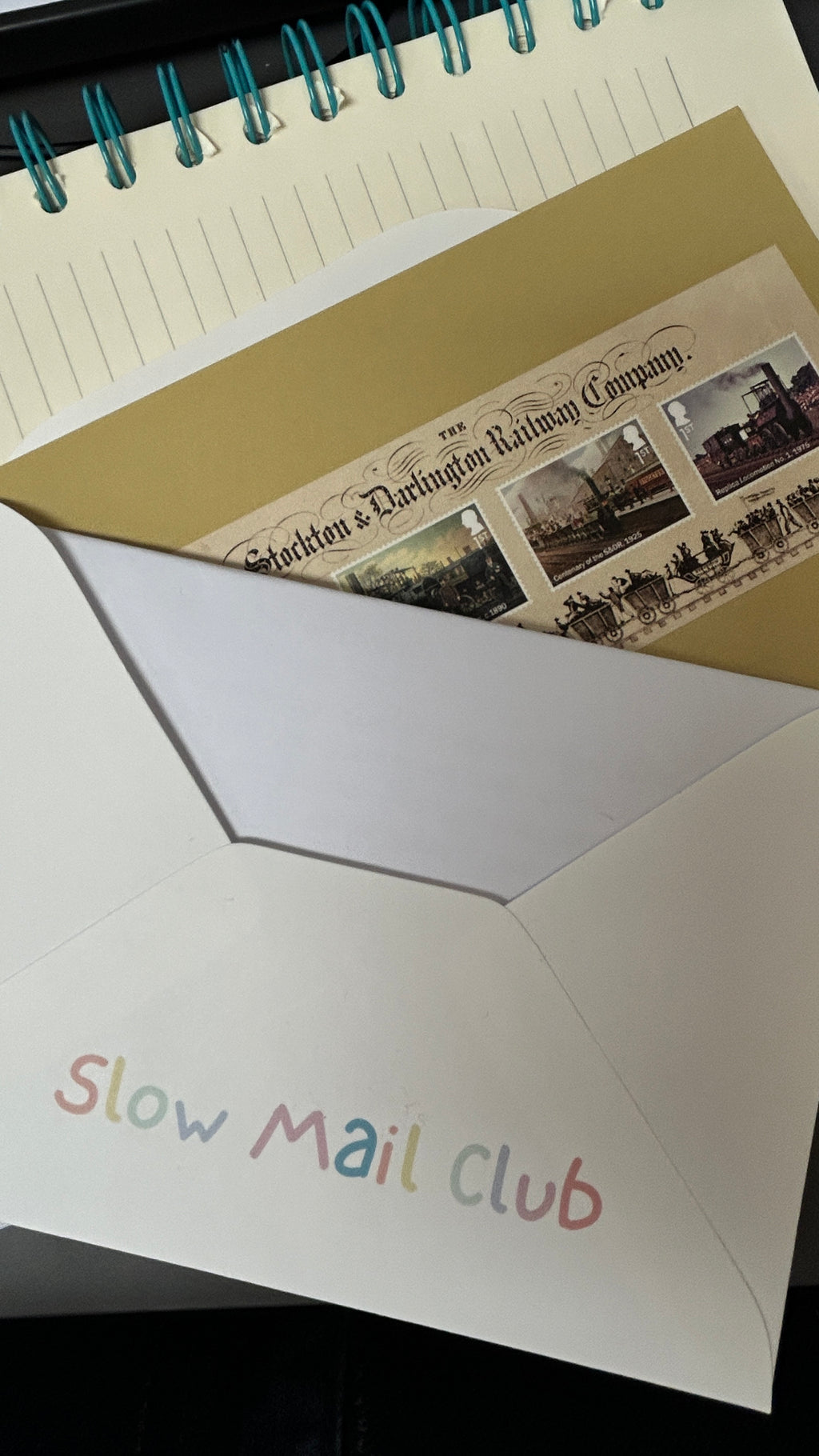 Envelopes with vintage-style stamp design and 'Slow Mail Club' text.