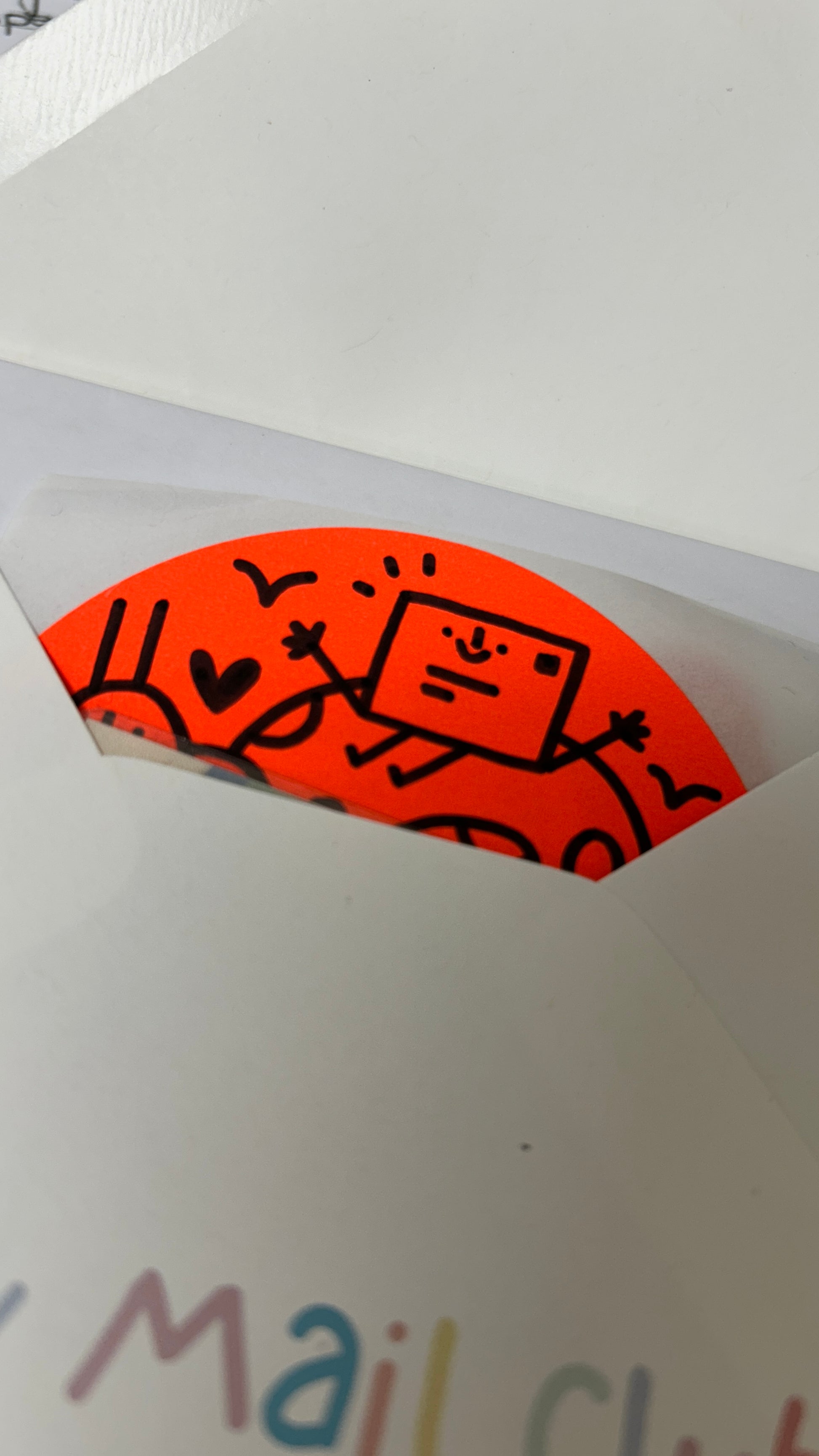 Orange sticker with cartoon design on a white envelope